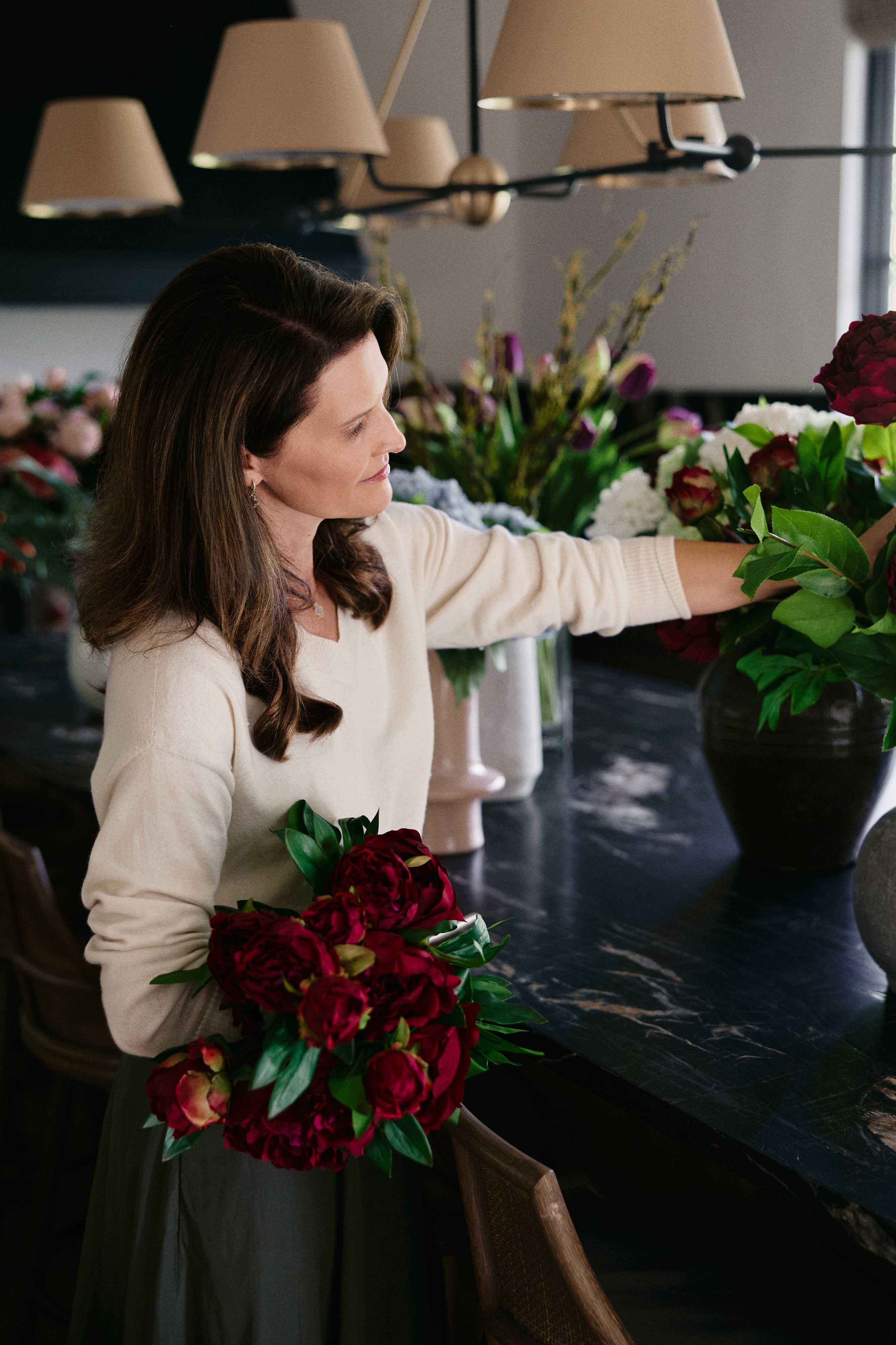 Woman arranging artificial flowers